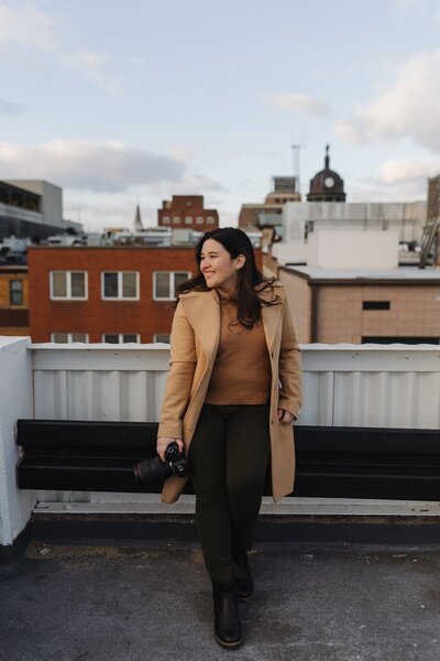 jennifer kahl holds camera on rooftop
