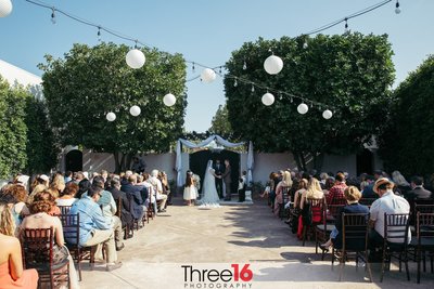 Outdoor wedding ceremony as guest look on at the Casa Bonita Event Center in Fullerton