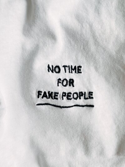 Words "No Time For Fake People" on a white cloth