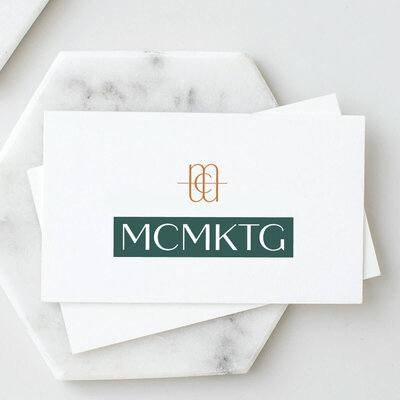 Business cards with logo text "MCMKTG"