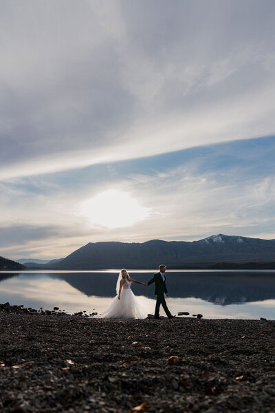 Close-up of a couple’s hands during their elopement, showcasing a diamond engagement ring and matching wedding bands, captured by Joseph Mayden in natural light.