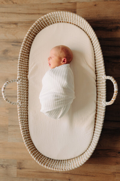 Asheville newborn photographer Rachel Marie Photography captures wrapped newborn baby boy in a basket