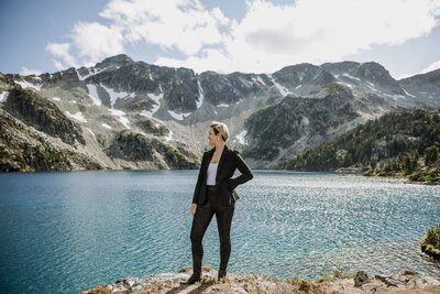 woman in black jumpsuit standing by BC lake