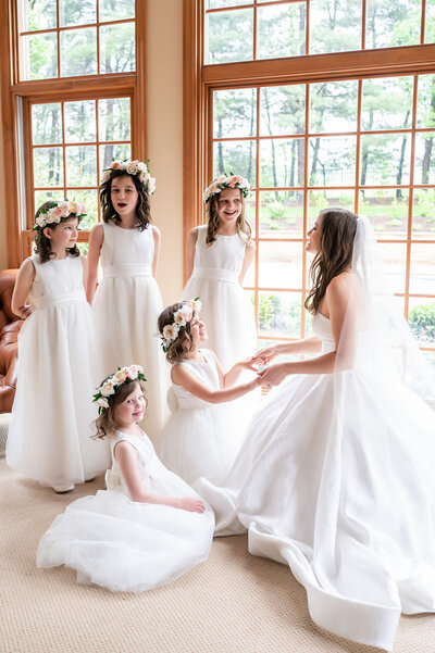 bride getting ready with flower girls