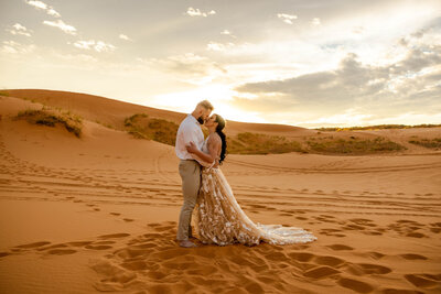 Kissing for an elopement in the sand dunes of Utah at sand hallow