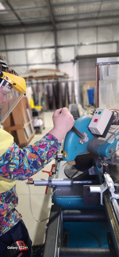Tom, an experienced technician at Roma Glass & Aluminium, ensuring community and respect in crafting and repairing glass products.