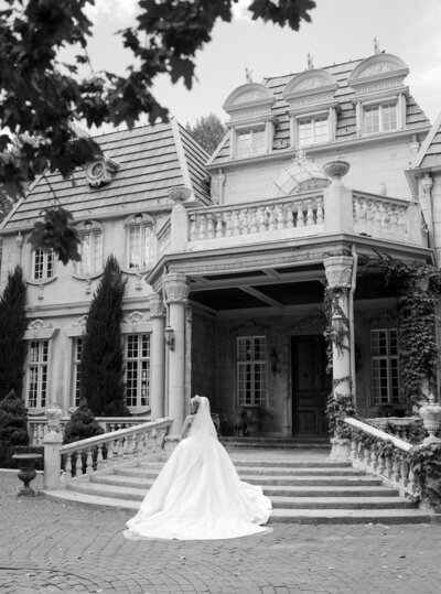 A woman in a wedding dress and hiking boots hikes through the Italian Dolomites