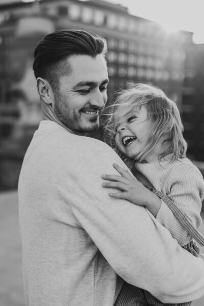 Black and white family shoot of man holding child