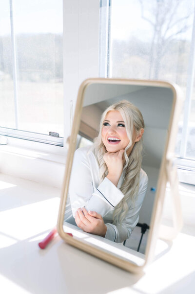 arkansas wedding photograph featuring bridal bride laughing in mirror