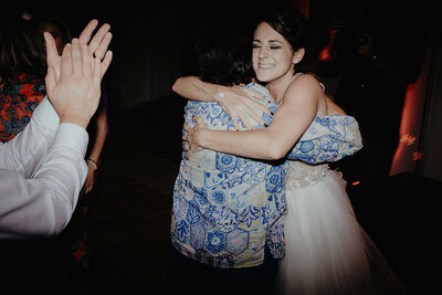 Katherine, of Crossed Keys Estate team, embraces bride in warm hug on her wedding day