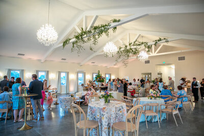 Crystal chandeliers and white beams with greenery