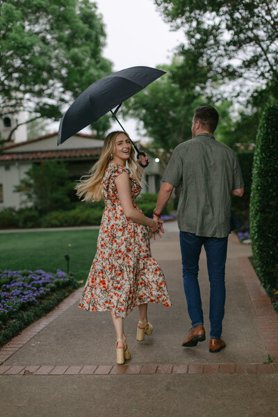 couple walking in the rain with umbrella