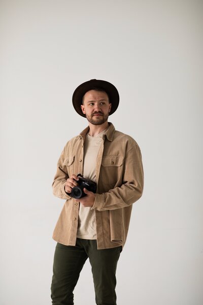 headshot of Nick holding camera