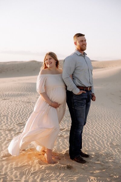 portrait of maternity couple at the sand dunes in Texas photo taken by maternity photographer in Lubbock Texas