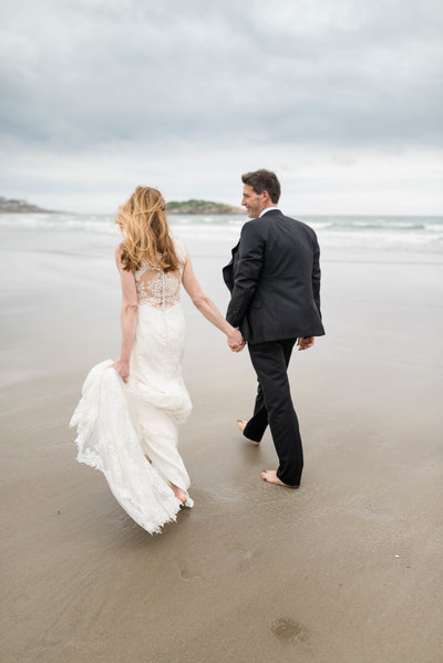 Married Couple Walking on the beach hand in hand