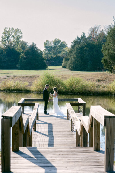 A wedding photo of a bride and groom during their first look