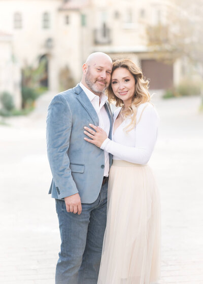 Gorgeous couple embracing in beautiful light and airy portrait