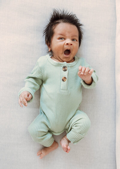 Yawning newborn baby during photo session in Naperville, IL