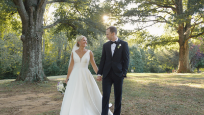 Couple walks through hydrangeas at Pippin Hill in Charlottesville, Virginia.