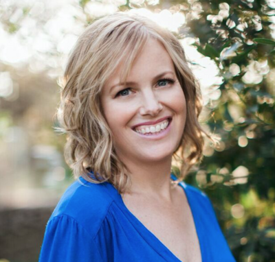 smiling blonde-haired woman wearing a blue shirt