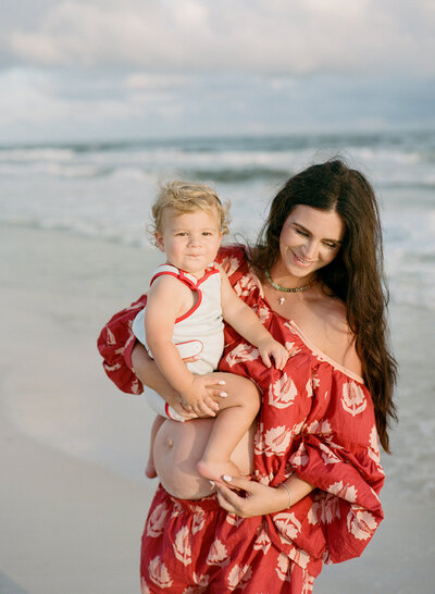 film photo of a pregnant mom holding her baby boy 