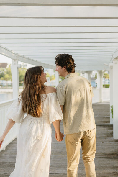 couple walking away from camera holding hands