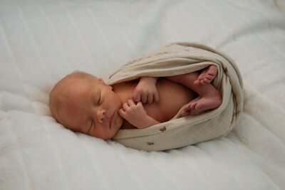 newborn laying on back