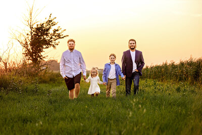 Family of four having fun during their outdoor photography session near Comfrey, Minnesota.