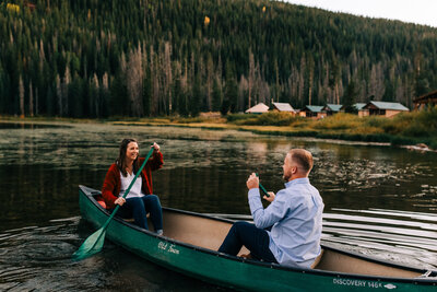 couple canoeing in the mountains during engagement photoshoot in the mountains of Colorado