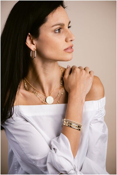 woman posing with jewelry during a product photography shoot