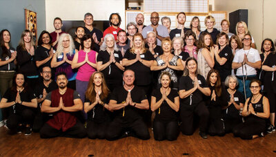 team branding portrait Zen Wellness staff all with hands clasped together in front of chest