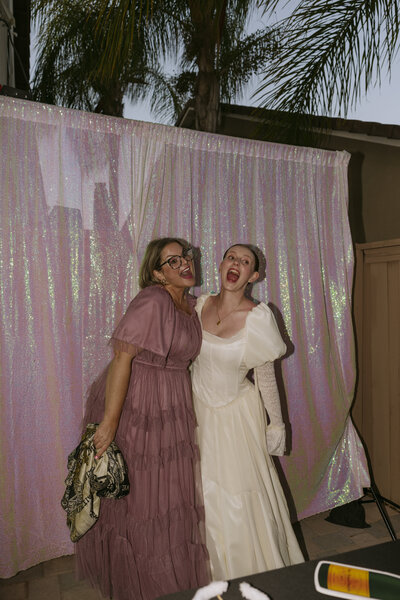 Regan and her Mother taking a silly photo together in the photo booth at Regan's wedding.