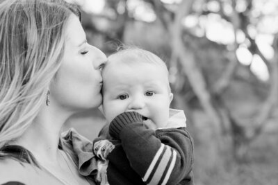 Mom kissing baby's head in Fort Ord