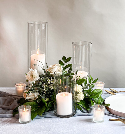 Small arrangement of white flowers with greenery on a table