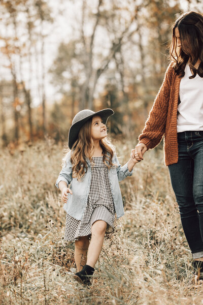 Little girl takes a walk for some cute family photos in Wisconsin.