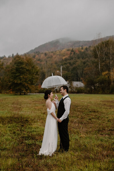 bride and groom under umbrella