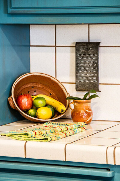 place branding Gatos Trail Ranch kitchen insert fruit bowl with potted plant on counter
