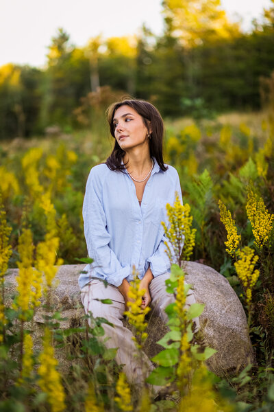 Senior sitting on a rock in blue shirt | Senior Photography Session