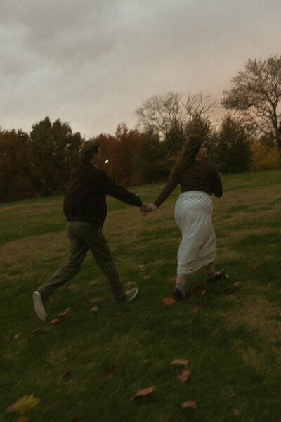 Couple playing in the park in Missouri during engagement session