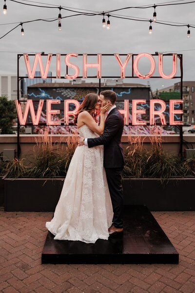 Bride and groom share first kiss during downtown Denver wedding.