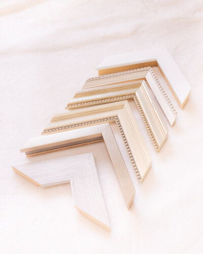 Collection of sample frame corner options displayed for clients to visualize wall art design choices