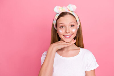 teen smiling ready for a facial treatment