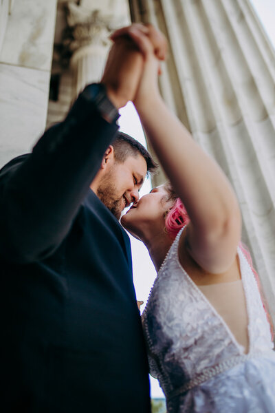 bride and groom kissing on church steps