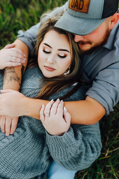 Couple cuddling close for their engagement photos in Baton Rouge
