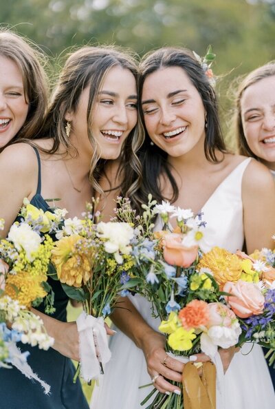 A bridal party enjoys their bespoke bouquets in Texas.