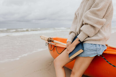 _a-young-woman-with-a-book-on-the-seashore