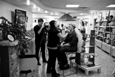 Brian Johnson, owner of With This Ring Wedding Films + Photo, filming a bride and groom during a destination wedding in Mexico under palm trees on a sunny beach