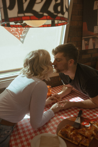 couple kissing at pizza hut, michigan editorial wedding photographer