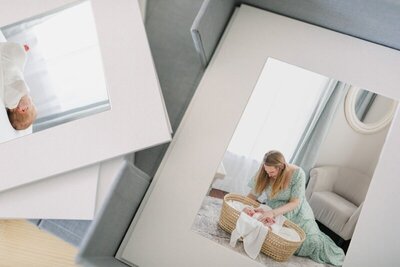 A box of matted prints that show images from a NJ Newborn photo session photographed by Kate Voda