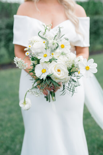 Bride holding white and green floral bouquet